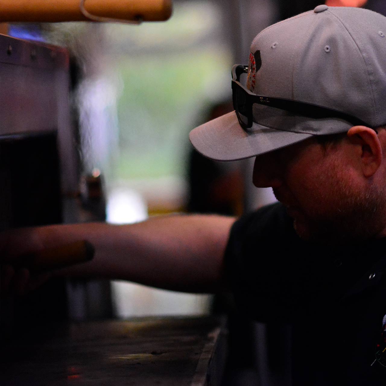 Man wearing a gray baseball cap and sunglasses at Emilio Finatti Pizzeria in Port Moody
