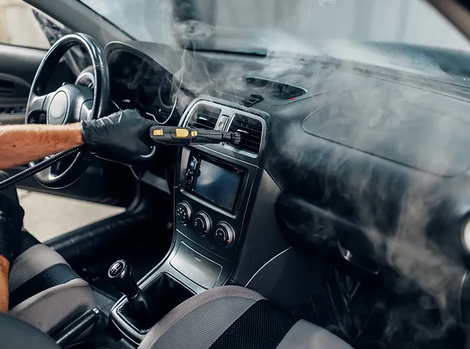 Interior of a car being detailed with steam cleaning equipment in Port Moody