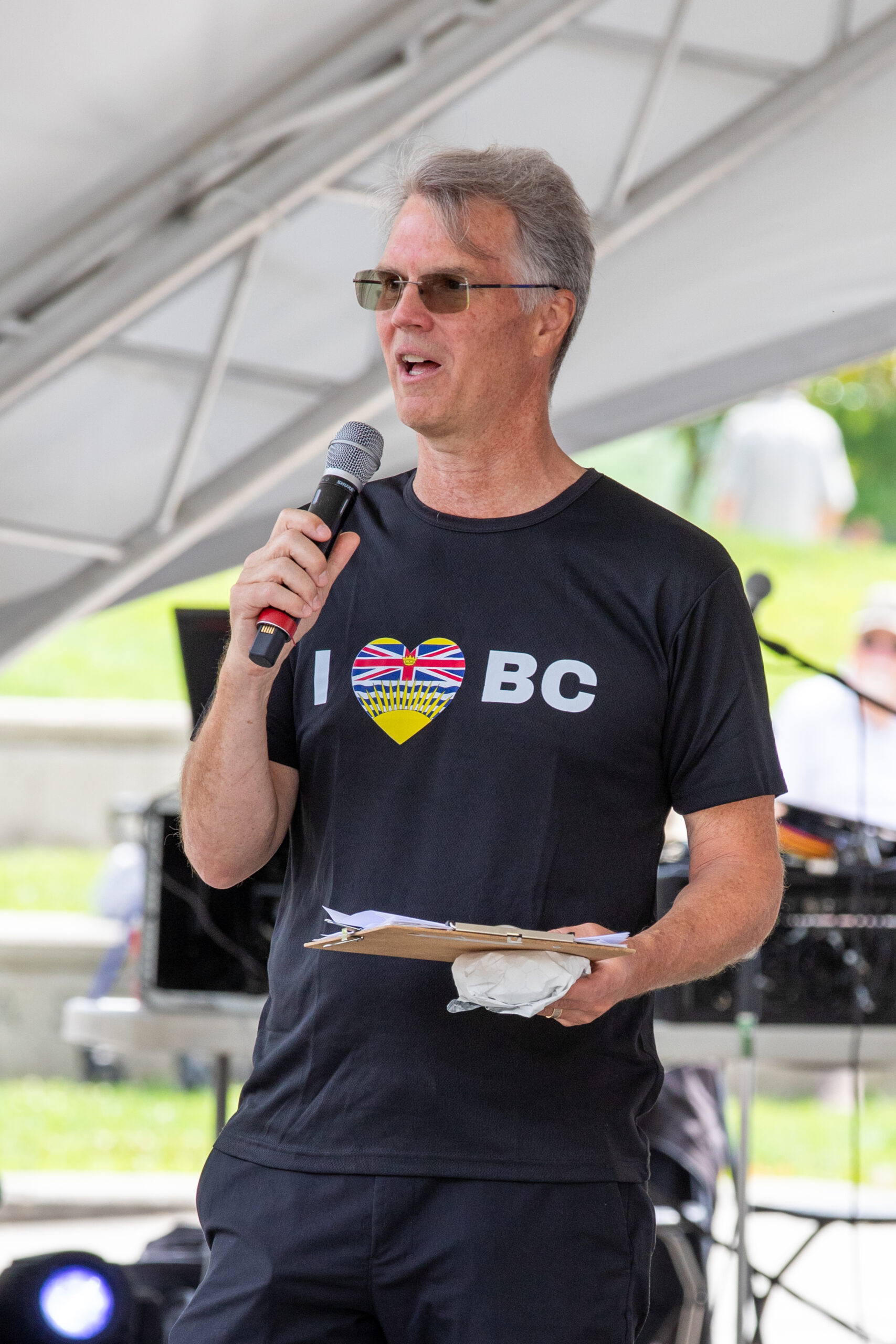 Event host addressing the crowd at a past Celebrate BC festival, Photography Credit Tina-Louise Harris