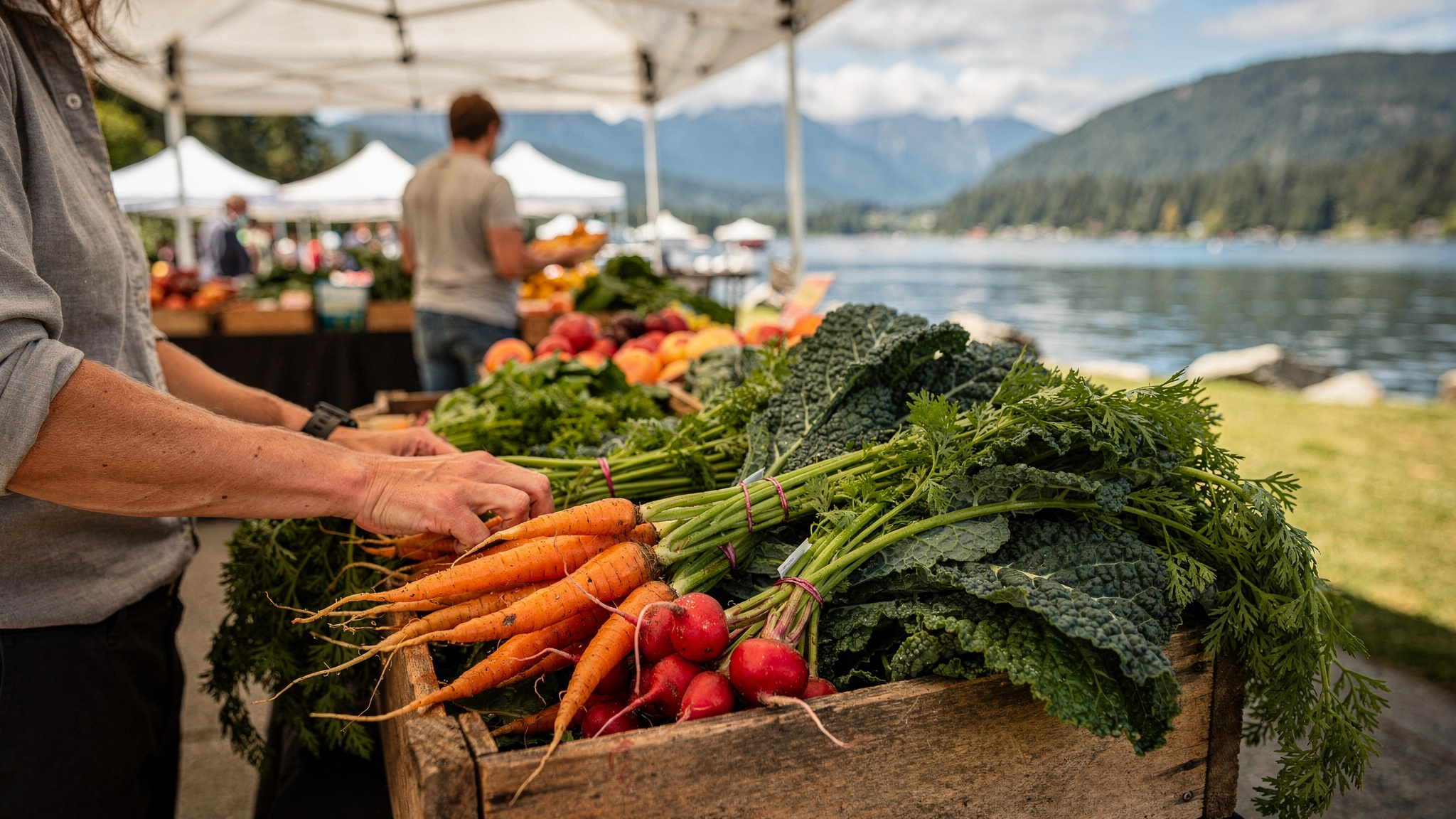 Farmers market produce crate with carrots, radishes, and kale at a Port Moody waterfront market