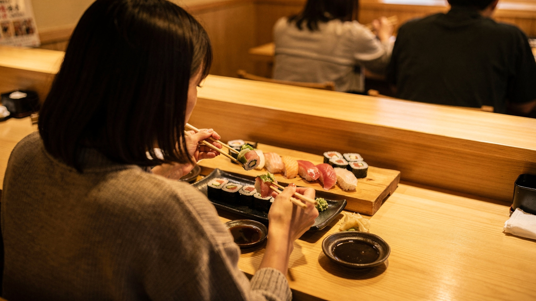Diners enjoying a spread of fresh sushi at a Port Moody restaurant